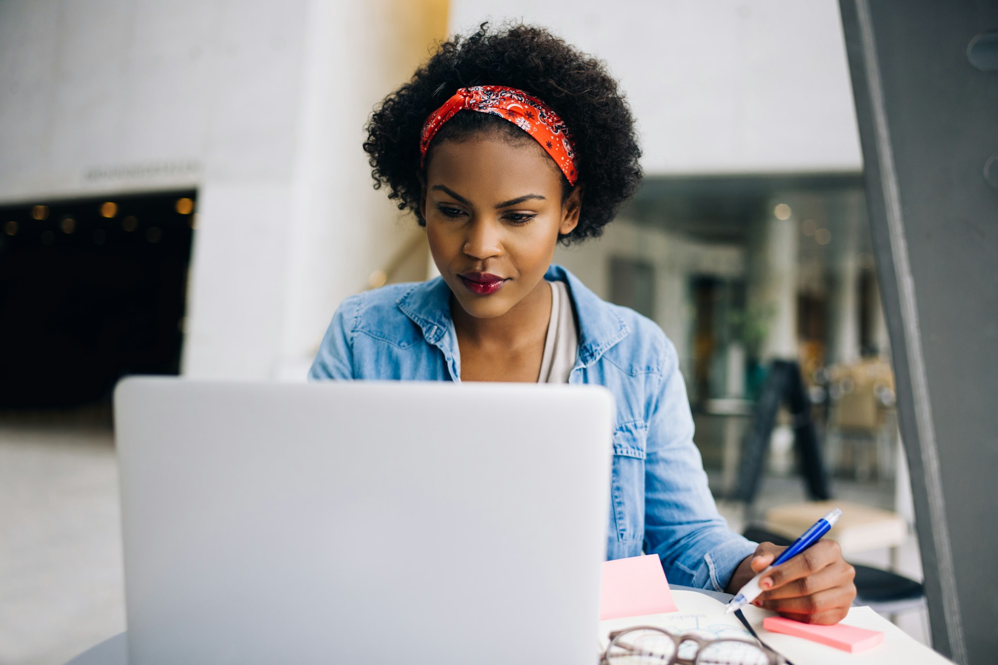 Focused young African female entrepreneur working on a laptop